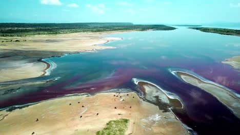 Aerial-View-Of-Motorcycles-On-Flat-Soda-Lake-Of-Magadi-In-Rift-Valley,-Kenya,-East-Africa