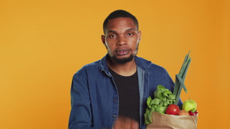 African-american-secretive-guy-doing-mute-hush-gesture-with-finger-over-lips