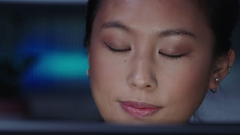 close up portrait beautiful asian business woman working late using tablet computer browsing brainstorming looking at information on screen