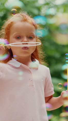 young girl playing with bubbles outdoors