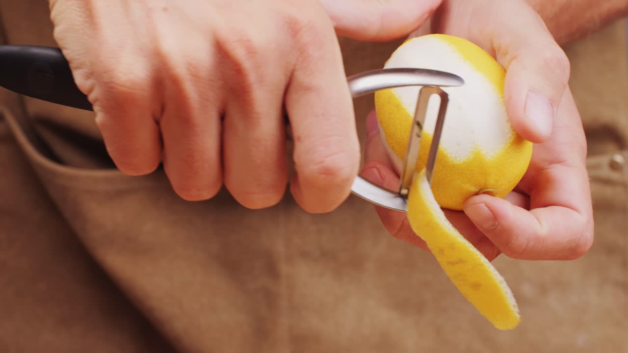 bartender makes a cocktail in a glass with orange peel. High quality 4k footage