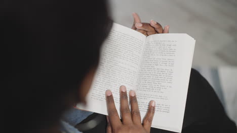 indian woman reads interesting history book flipping pages