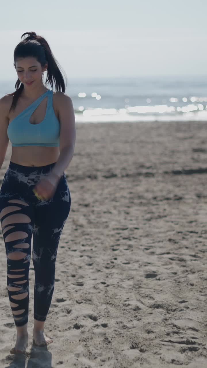 Woman in activewear on the beach