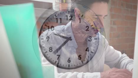 Animation-of-clock-ticking-over-caucasian-businessman-using-computer