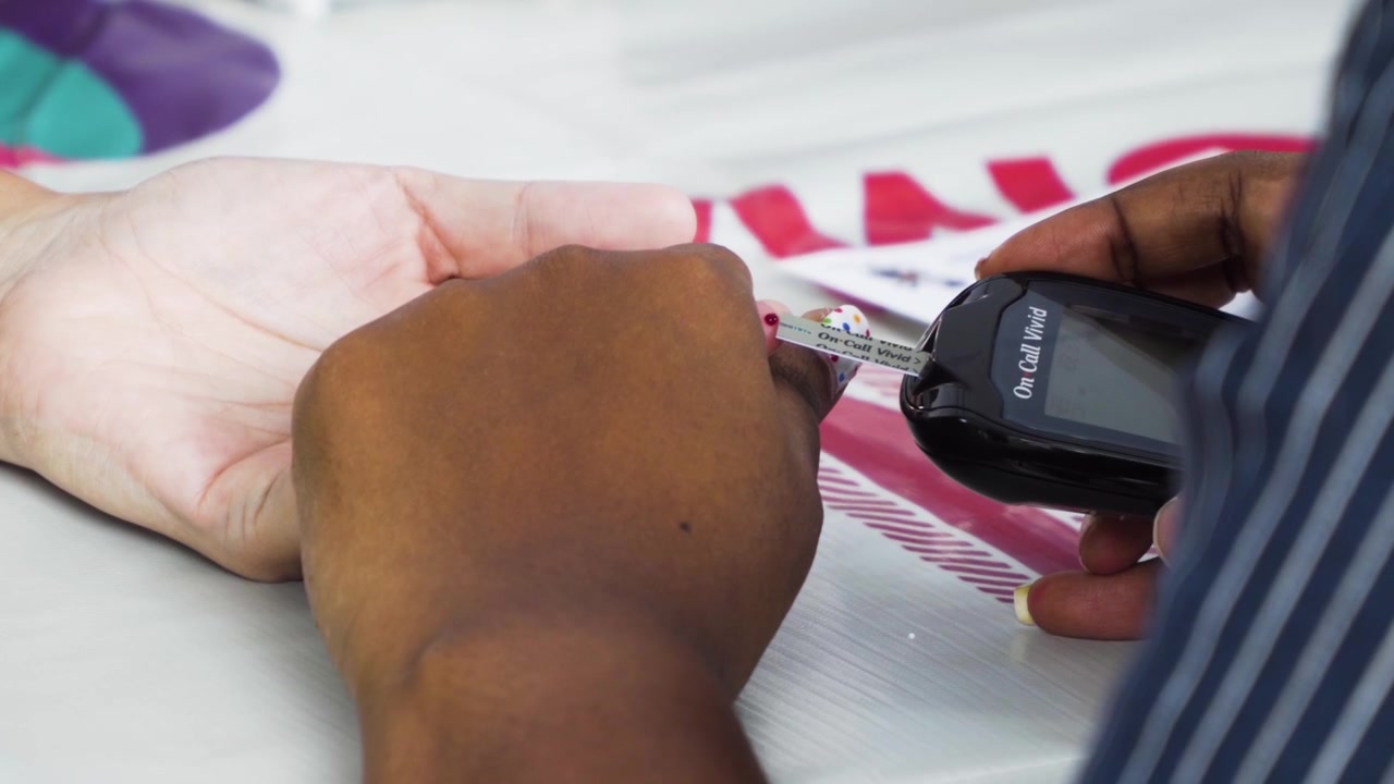 A handheld shot of a doctor drawing blood sample from a person's finger, in 4k 30fps.