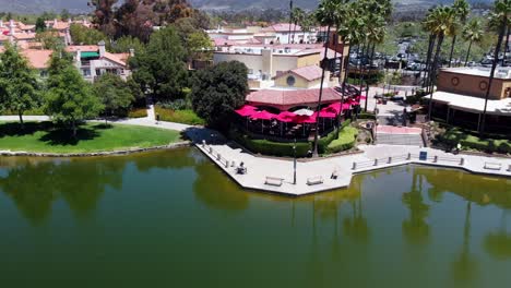 aerial pan shot of a restaurant on a community lake