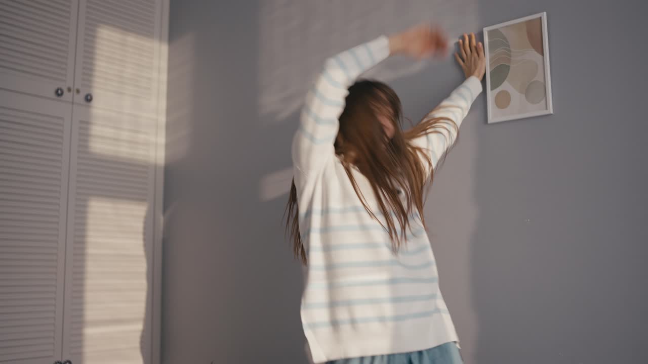Woman dancing indoors with joy