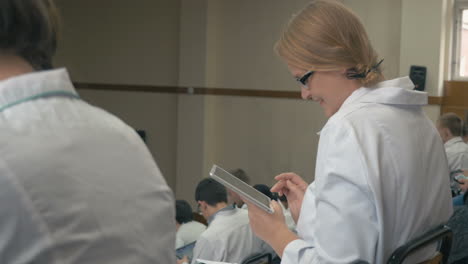 smiling medical student with pad on the lecture