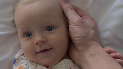 dad stroking head of baby daughter