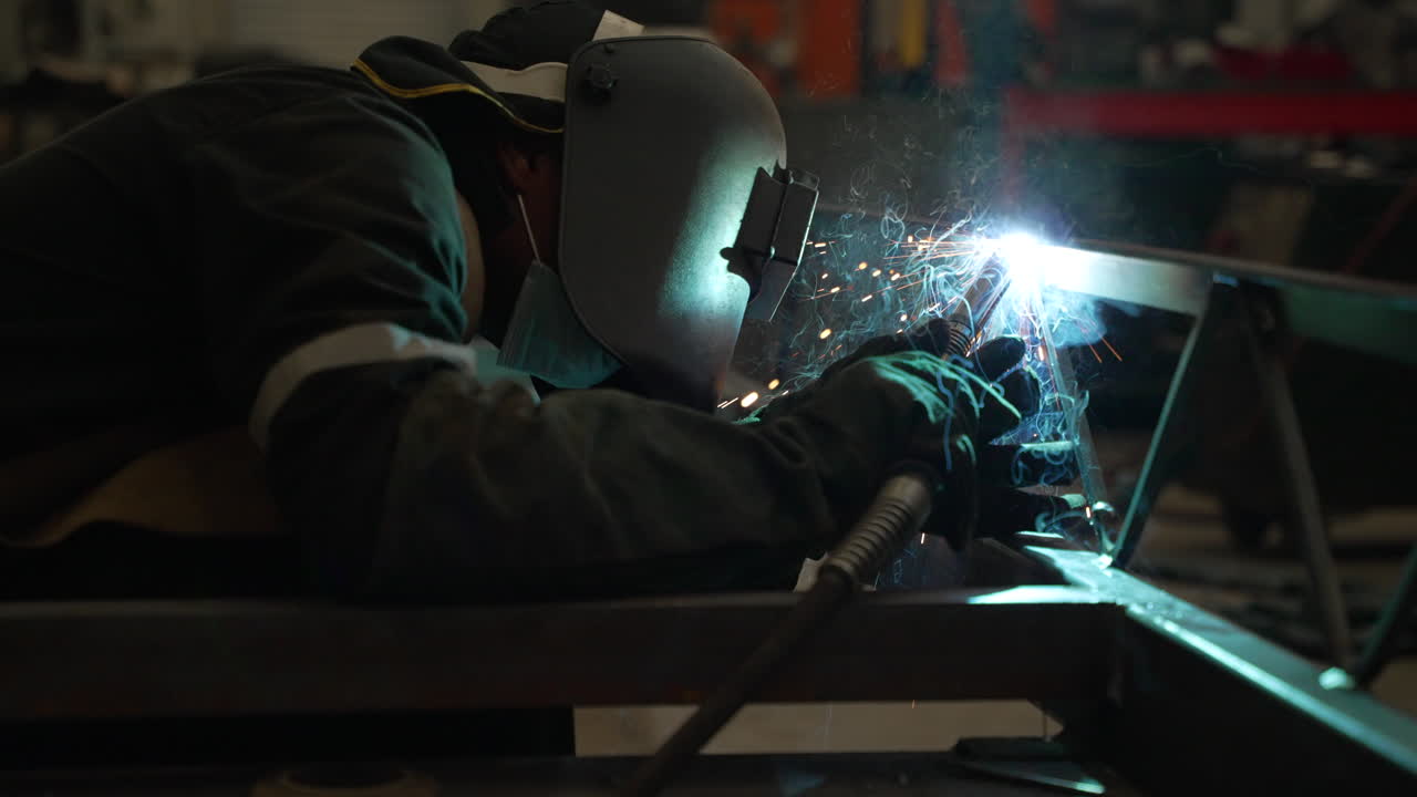 Welding in dark factory. 4K 100FPS