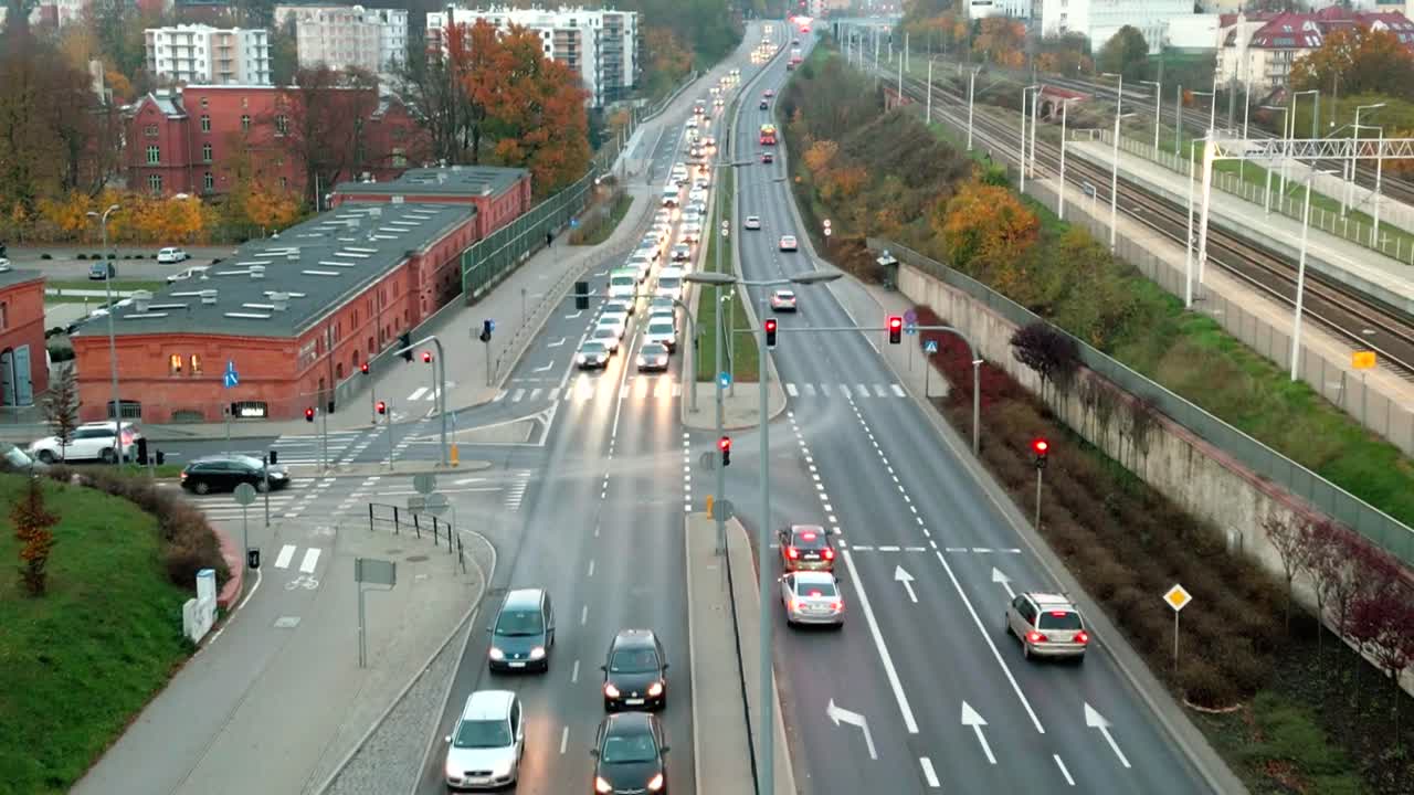 Busy street next to train tracks in downtown area viewed from a bird's-eye view
