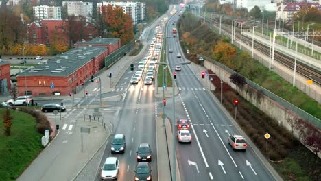 busy street next to train tracks in downtown area viewed from a bird's-eye view