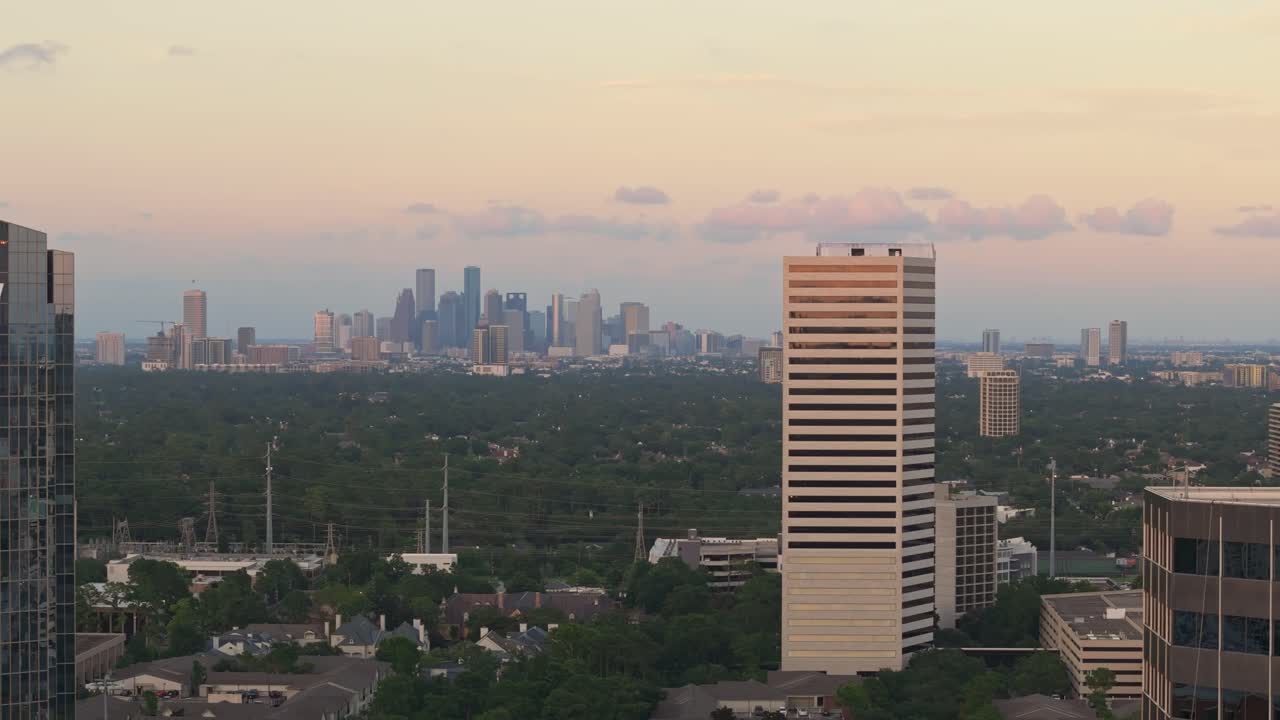 Downtown Houston skyline as viewed from Uptown at sunset, telephoto drone establishing shot
