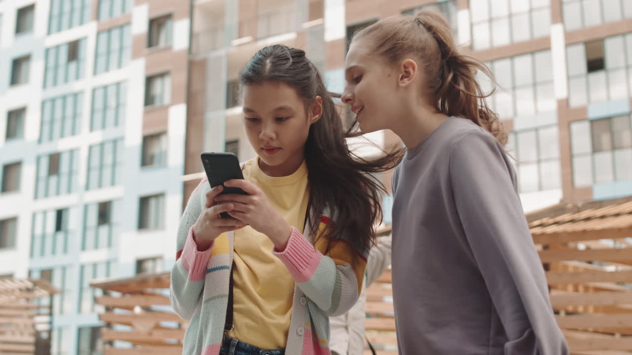 Girls Taking Selfie Portrait on Smartphone Outdoors