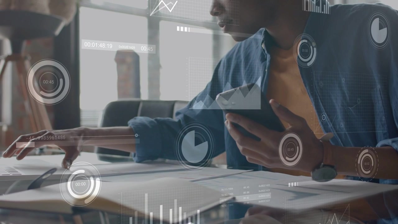 Analyst tapping phone at desk scanning charts while data overlays showing metrics for planning