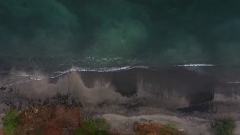 top drone shot of the dark coastline sea in panama