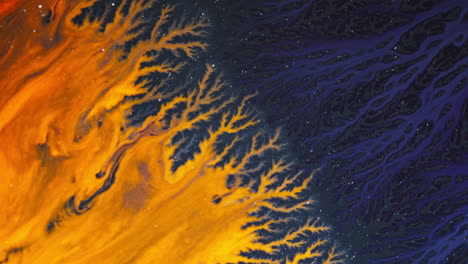 swirling ink patterns blending together in vivid macro detail, orange and blue hues