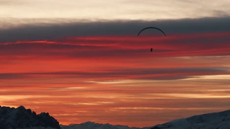 paragliding at sunset over the alps