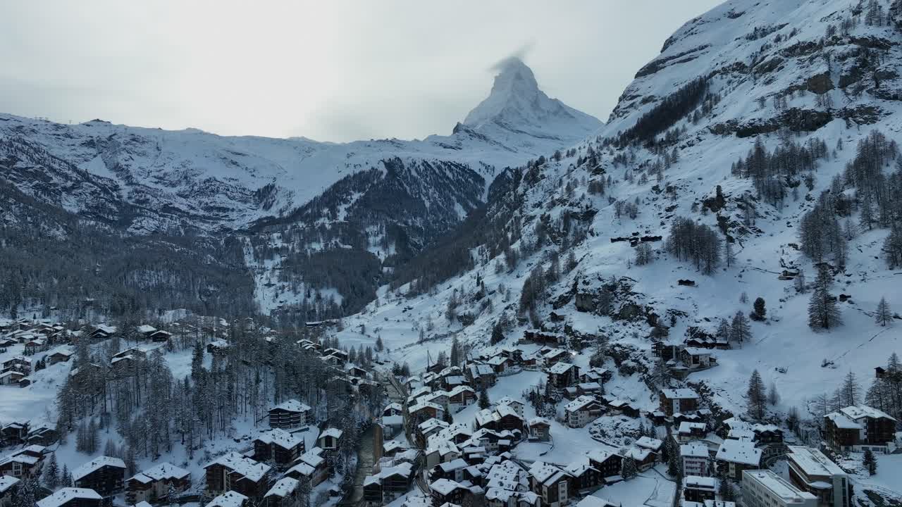 la ciudad de esquí de zermatt, suiza, en un frío día de invierno con el matterhorn y las dramáticas montañas de los alpes suizos en el fondo.