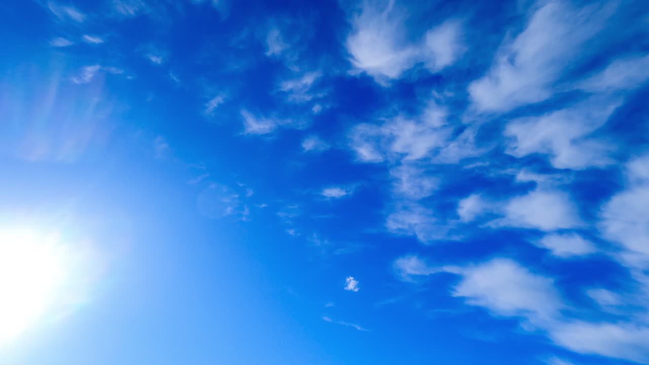 Grey rainy cloudscape covering the horizon. Clouds fly away, the blue sky clears up, the sun spears. Low angle view. Timelapse.
