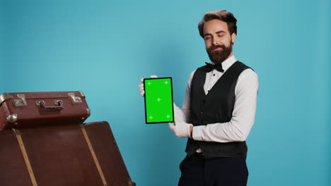 Elegant-bellboy-holding-tablet-on-camera