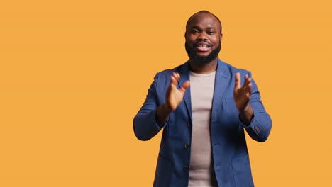 joyful man happily clapping hands, ecstatic, studio background