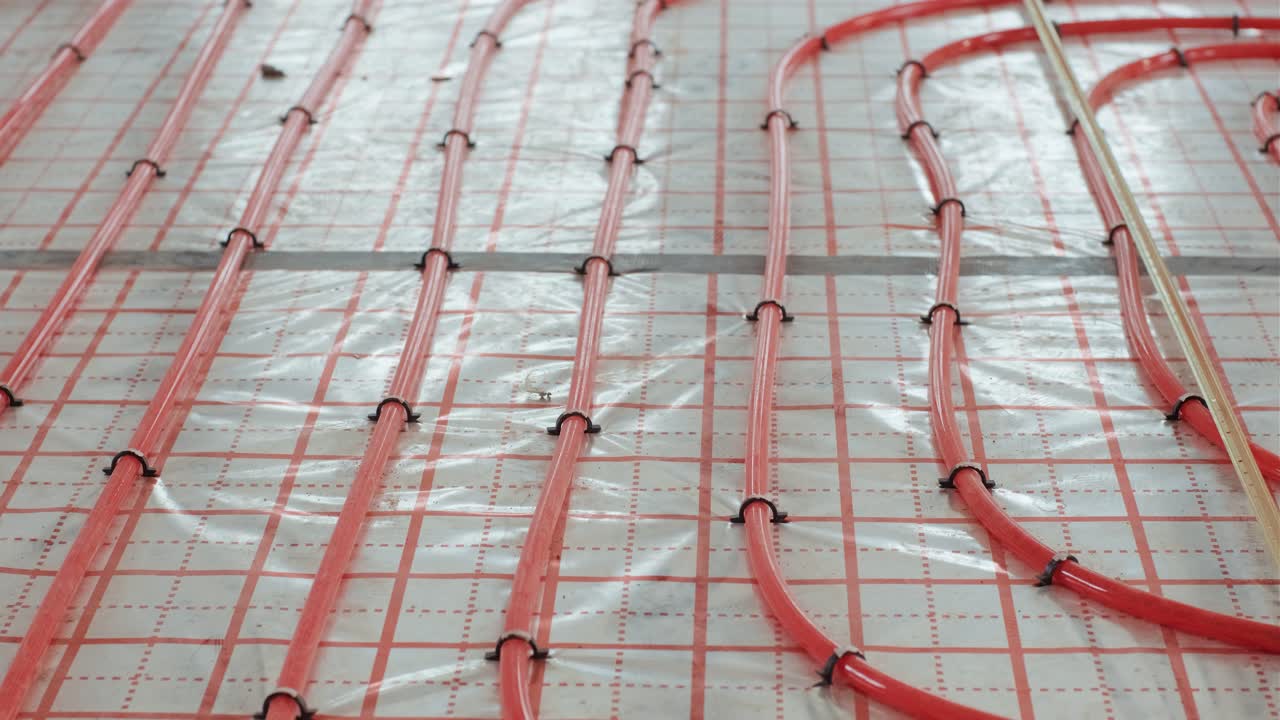 Installing underfloor heating pipes for water heating. Heating systems. Pipes for a heat-insulated floor.