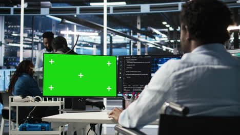data center engineer with paraplegia using ai algorithms on green screen pc
