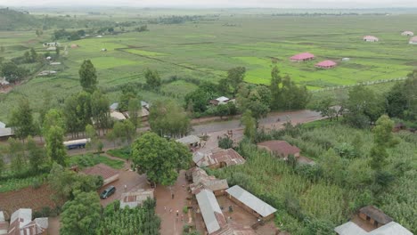 AERIAL---Small-town-and-agriculture-fields,-Jos-Plateau,-Nigeria,-forward-shot