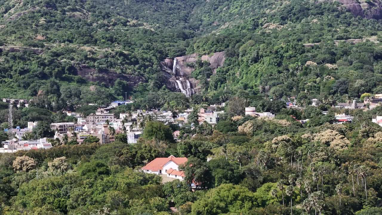 Aerial view of Courtallam, Tamil Nadu, showing waterfalls, temples, and lush greenery at the foothills of the Western Ghats, a popular ecotourism destination
