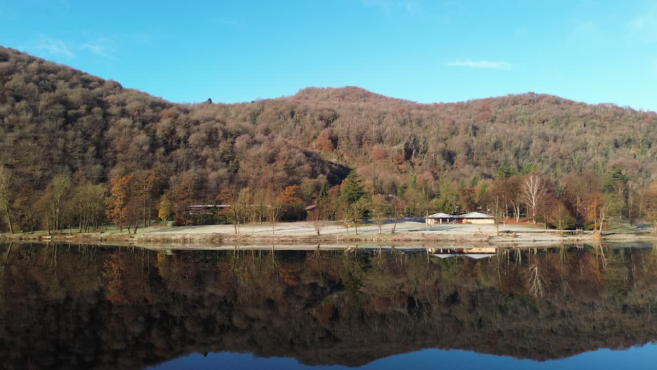 the landscape and panoramas and cabins that reflect the calm water in a morning where peace peeks through and the sky and water come together in a world. Drone shots views