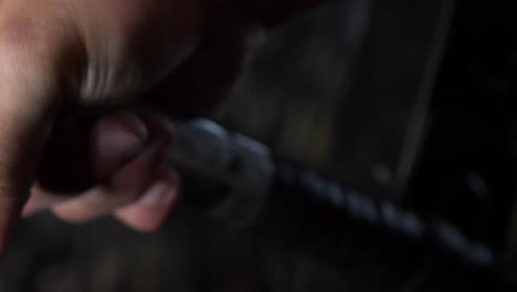 athlete's hand gripping standard olympic barbell getting ready to lift, close up slider shot