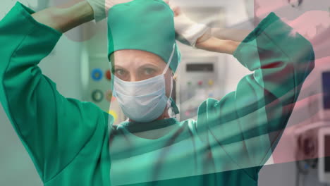 animation of flag of italy over caucasian female surgeon in hospital