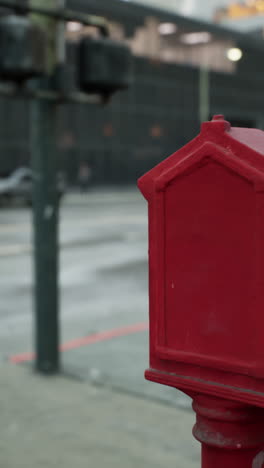 red fire alarm box on a city street