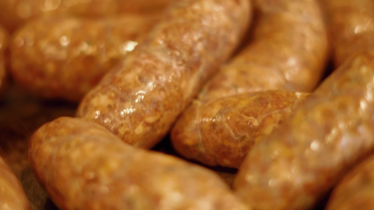 Fresh Pork sausage links in casings. 4k video. Food prep video