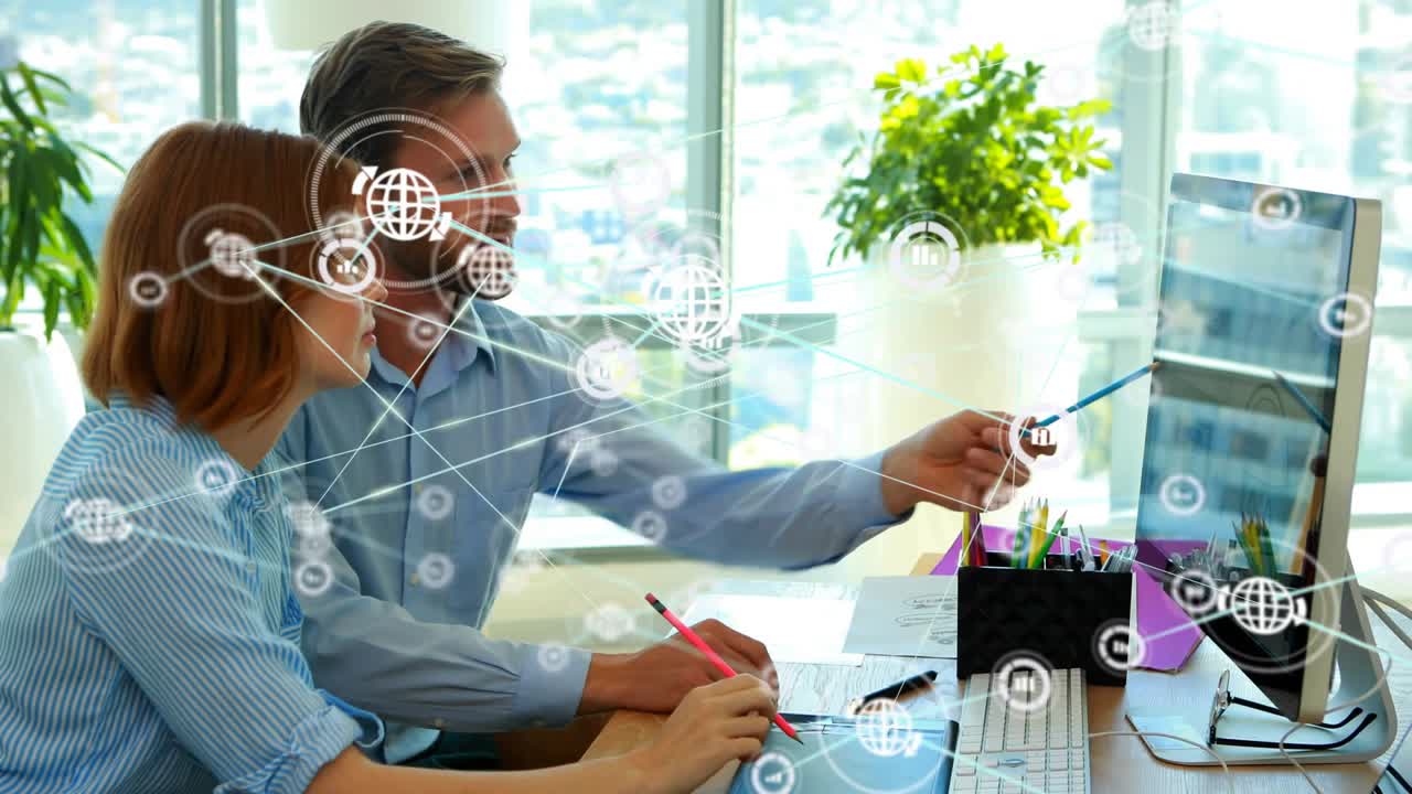 Man pointing pen triggers growing globe icons and lines while woman taking notes on business data