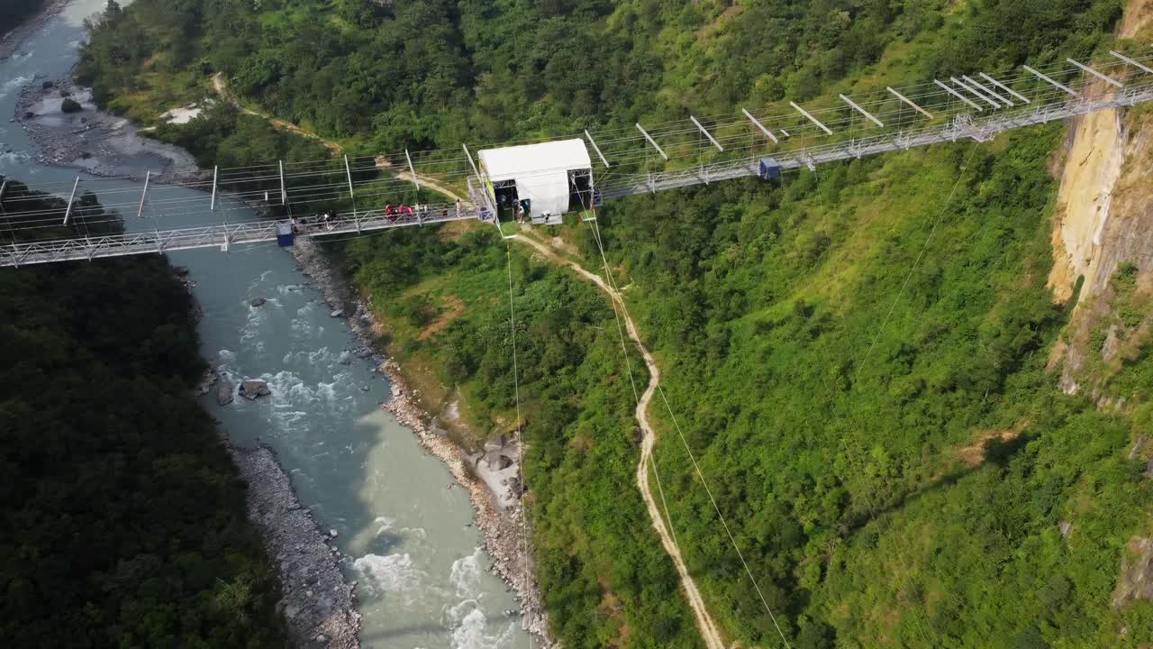 Aerial orbit shot showing bungee jumping spot of gigantic bridge with freefall in nepal