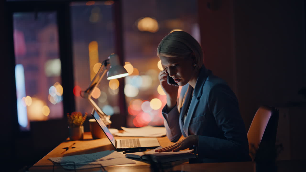 Calling manager hardworking late flipping notebook at night agency workplace