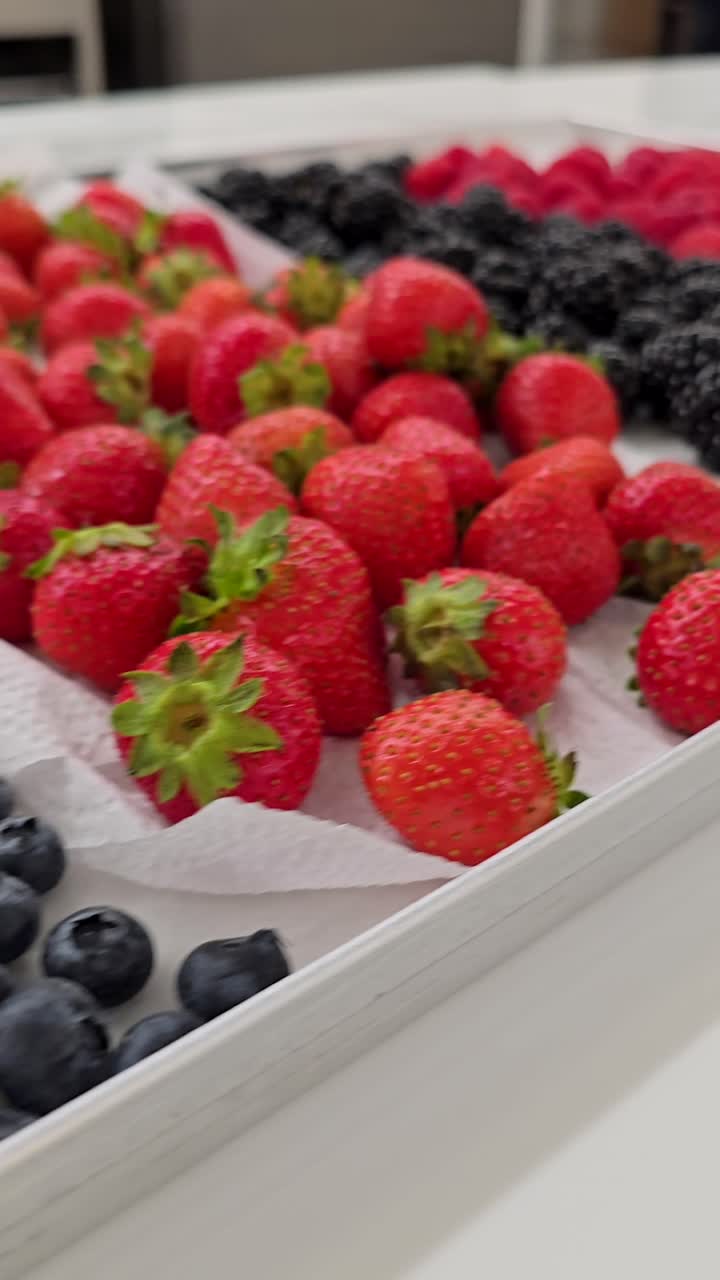A vibrant collection of berries ready for cake and muffin toppings at a bakery shop.