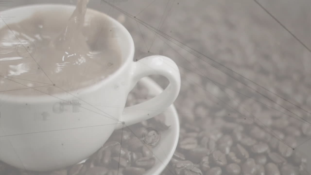 White ceramic coffee cup getting filled with hot coffee, creating ripples over scattered beans