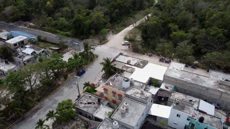 Aerial-shot-of-houses-near-to-the-forest-in-Akumal,-Tulum,-Quintana-Roo,-Mexico