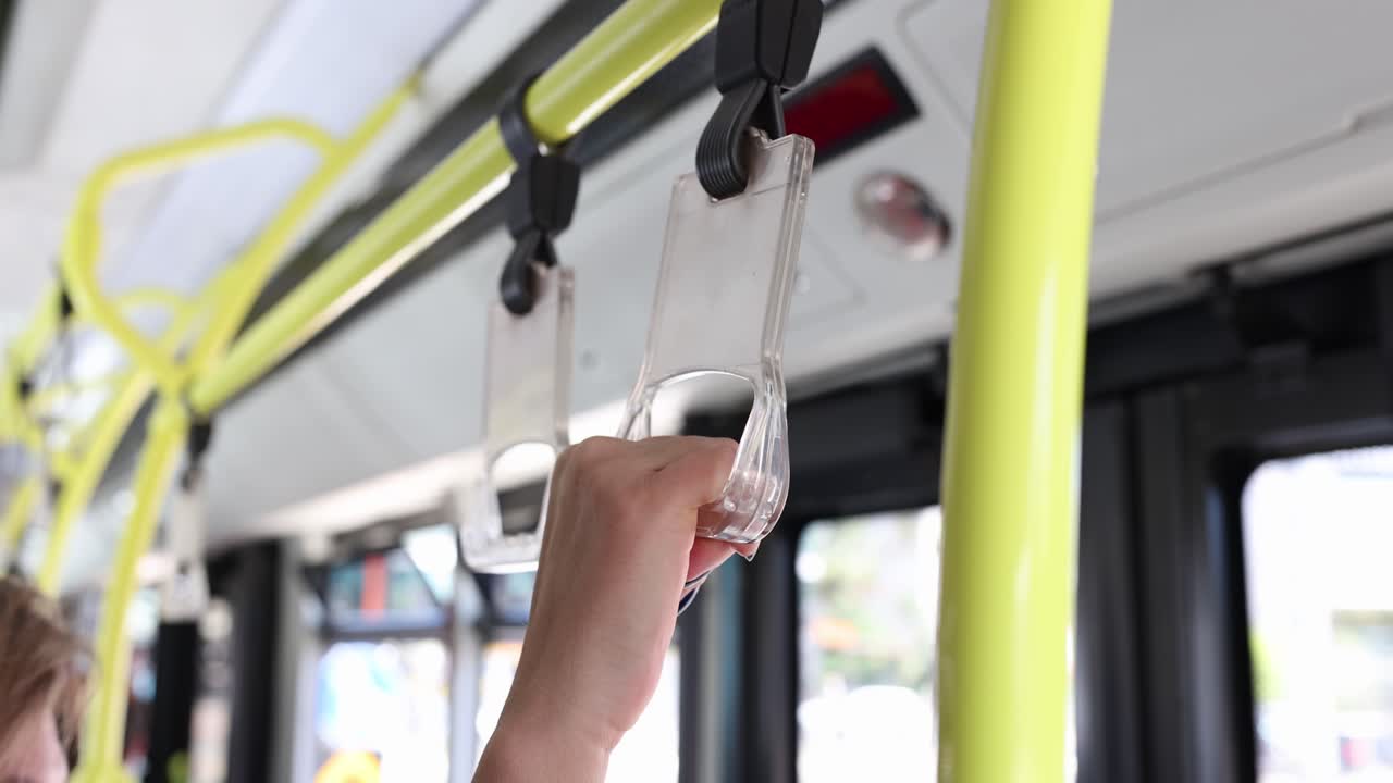 Hand holding bus handle