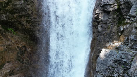 Beautiful-Forest-Waterfall-into-Clean-Pool-of-Blue-Water-[4K-Slow-Motion