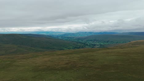 Vast Landscape of Rolling Hills and Valleys Under a Cloudy Sky