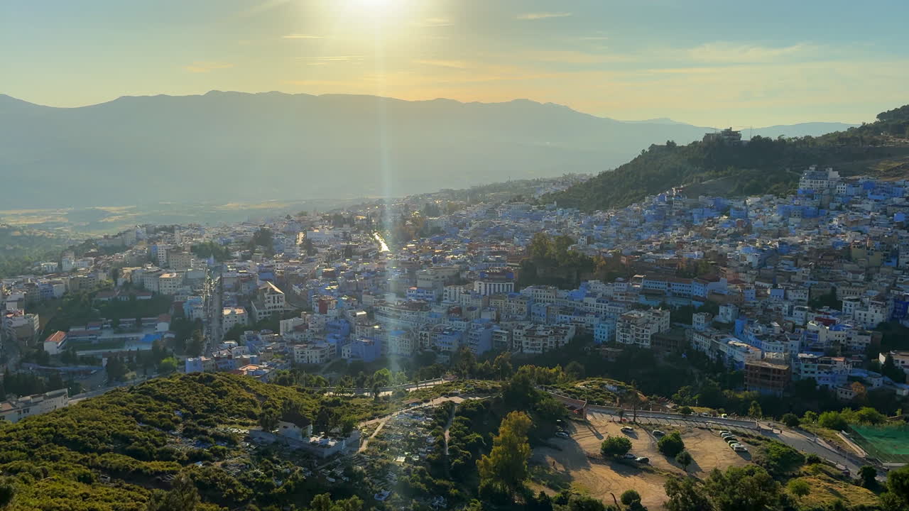 Chefchaouen beautiful blue city in golden hour. Panning view