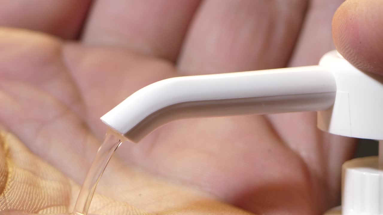 A man disinfects his palms with special antibacterial jellies