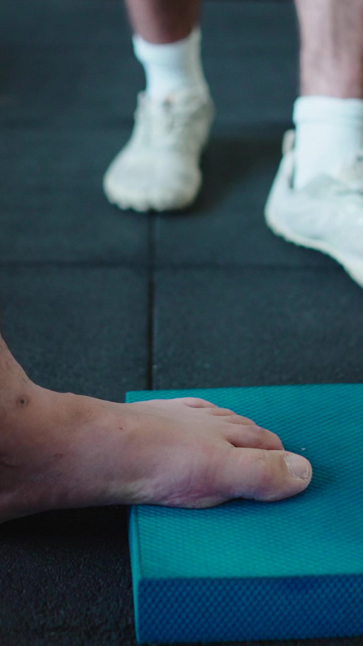 Physical Therapist Assisting Patient with Ankle Rehabilitation Exercise