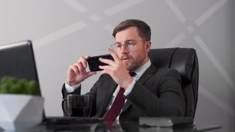 business man watching exciting video on phone