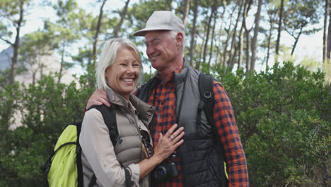 front view of active senior couple in forest