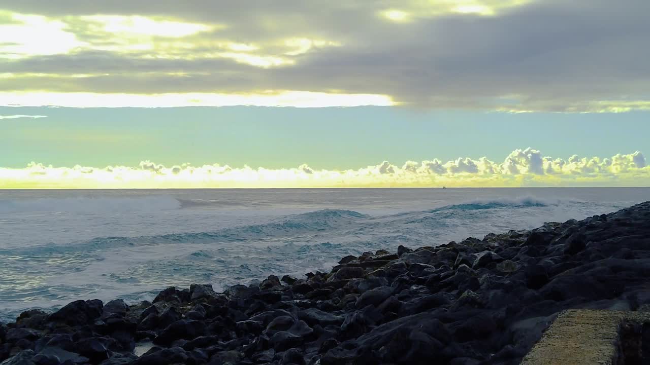 Serene Ocean Waves Crashing on Rocky Shore at Sunrise